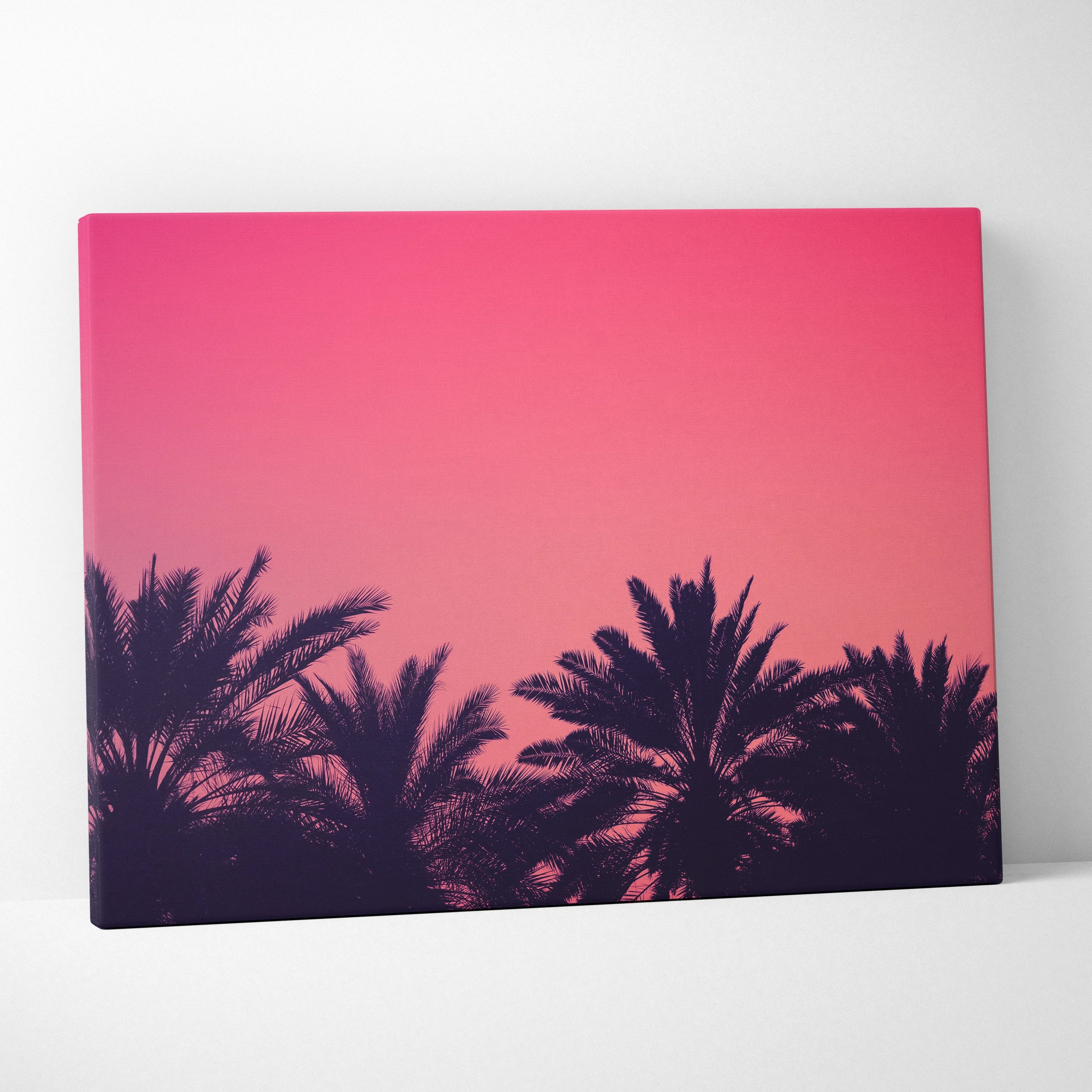 Canvas wall art featuring black palm trees silhouetted against a vibrant pink and purple sunset sky.