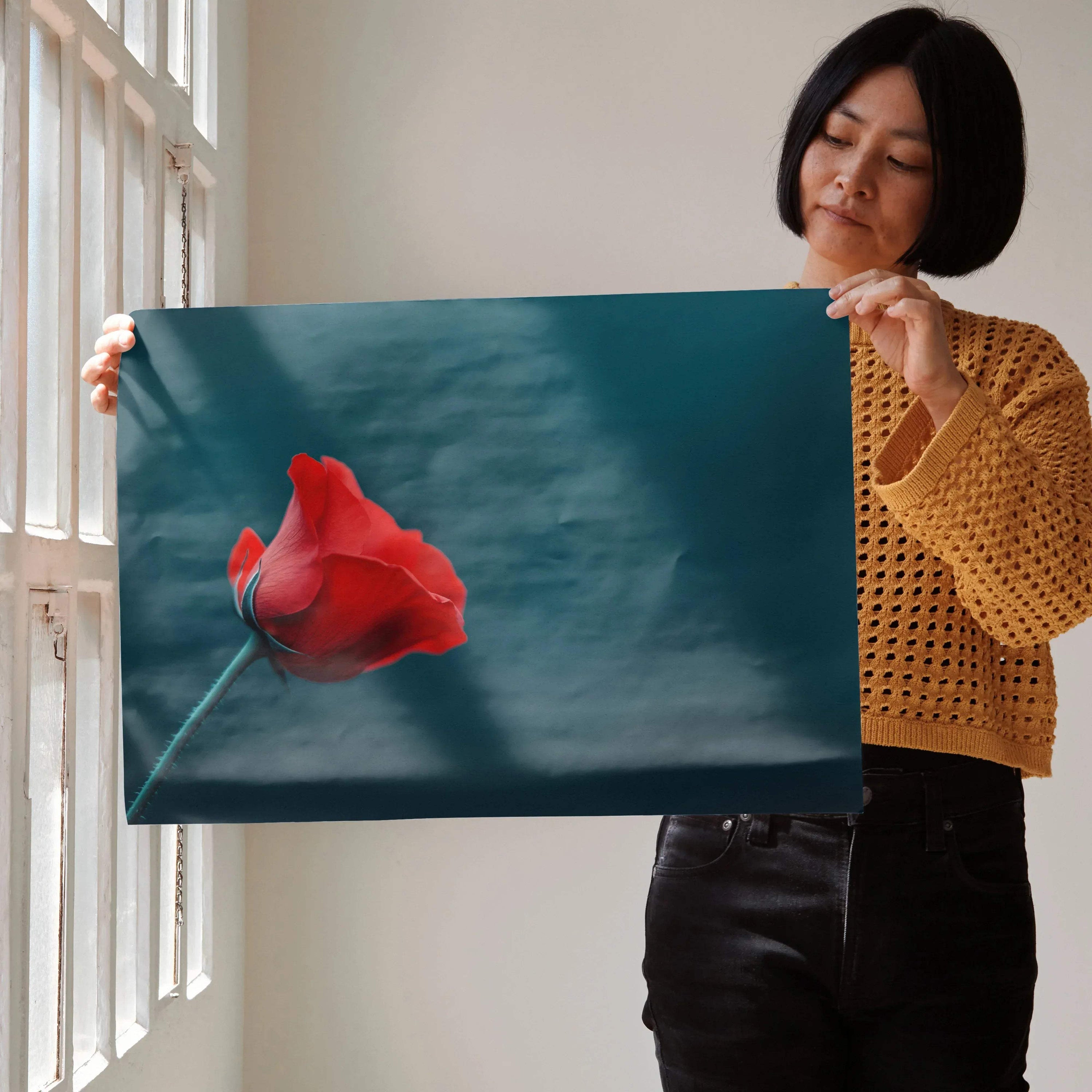 Vibrant red floral digital art poster on teal background held as wall art.