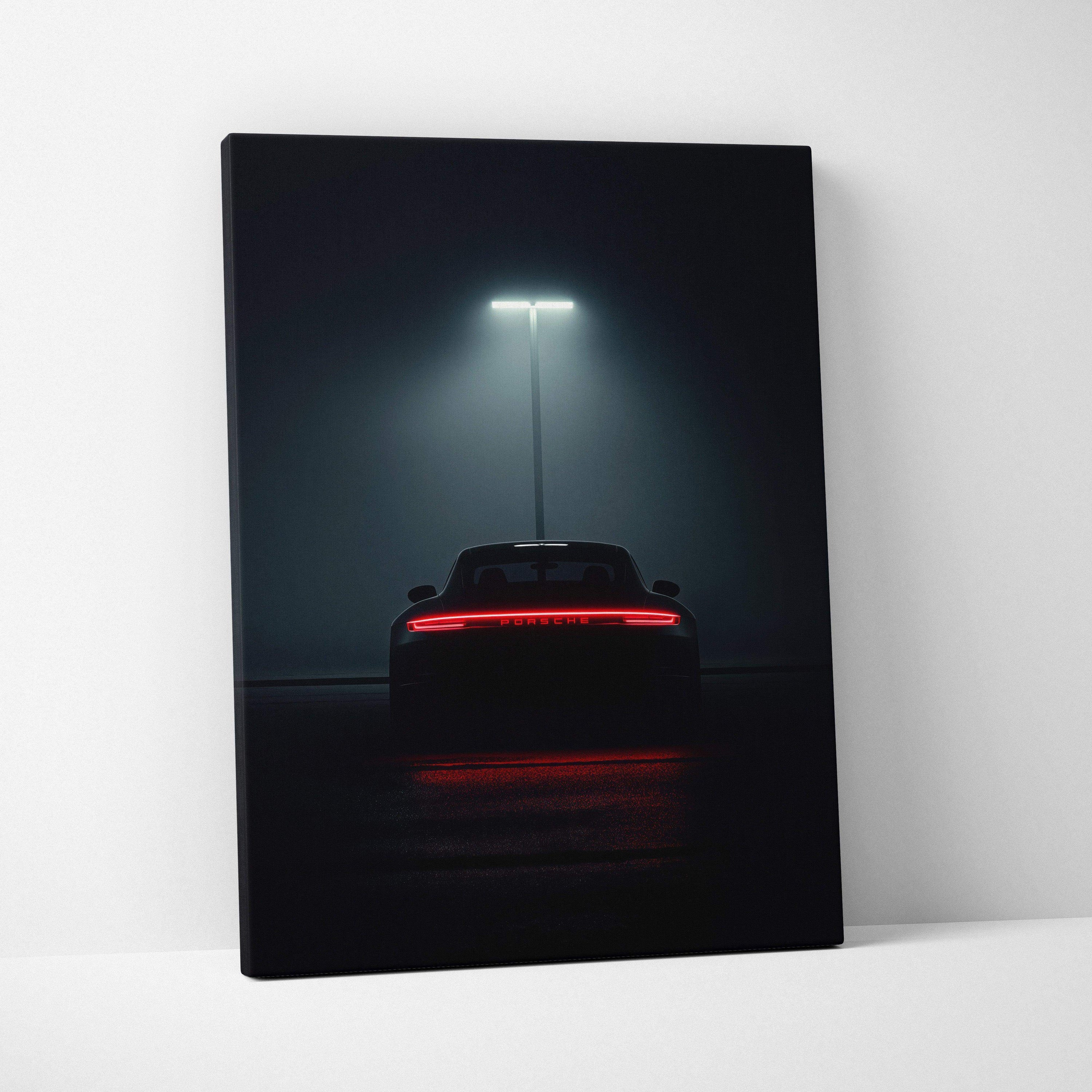 Dark canvas wall art featuring the rear view of a Porsche sports car illuminated by a single streetlight.