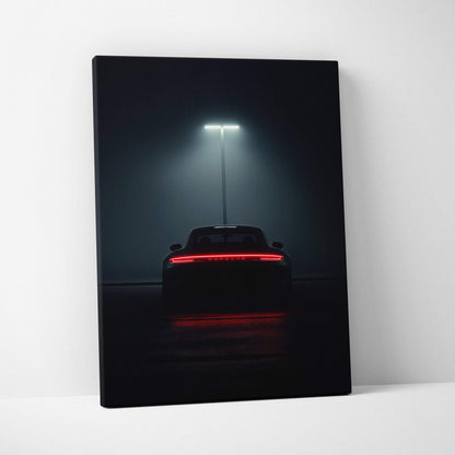 Dark canvas wall art featuring the rear view of a Porsche sports car illuminated by a single streetlight.