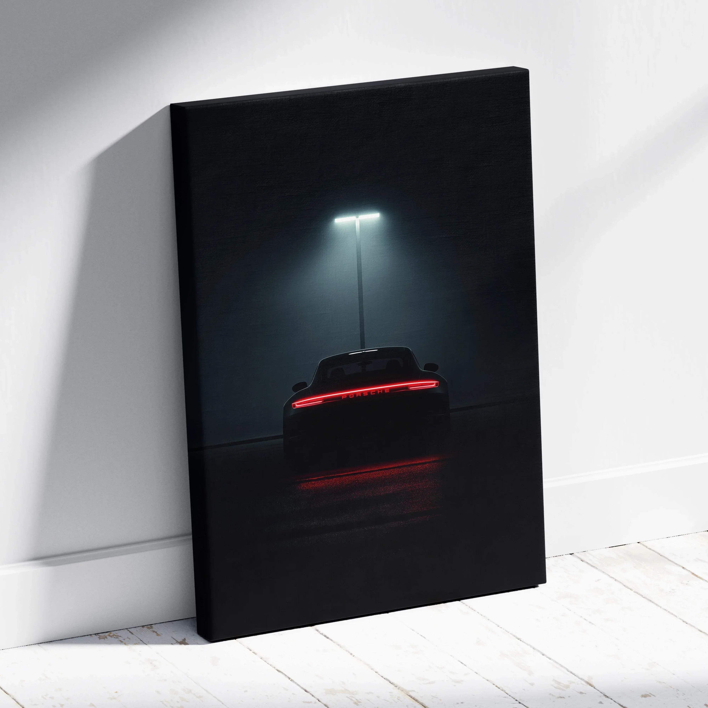 Dark canvas wall art featuring a rear view of a Porsche sports car illuminated by a single streetlight.