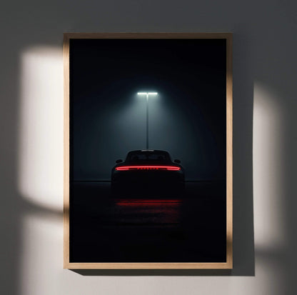 Vintage Porsche 911 Turbo rear view illuminated by overhead light poster wall art in black frame.