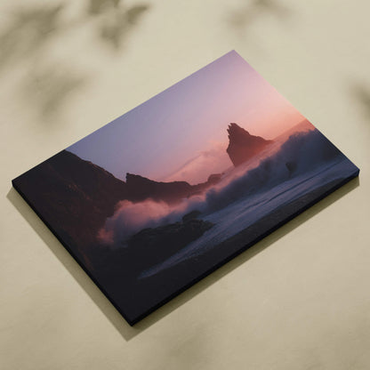 Cinematic coastal canvas art with dusky pink sunset, crashing waves on sea stacks