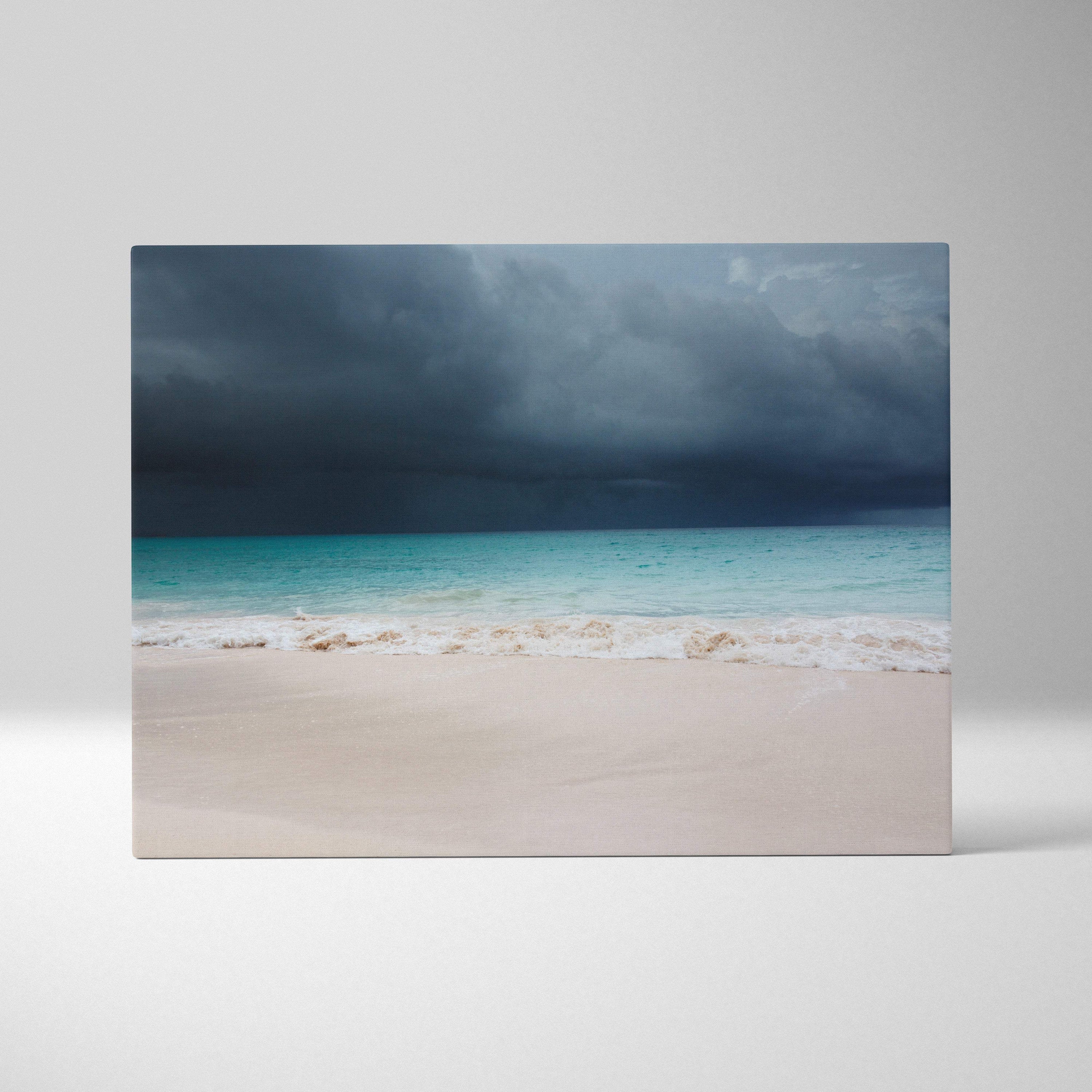 Stormy beach canvas art featuring turquoise waves white sand and dark thunderclouds moody coastal landscape wall decor