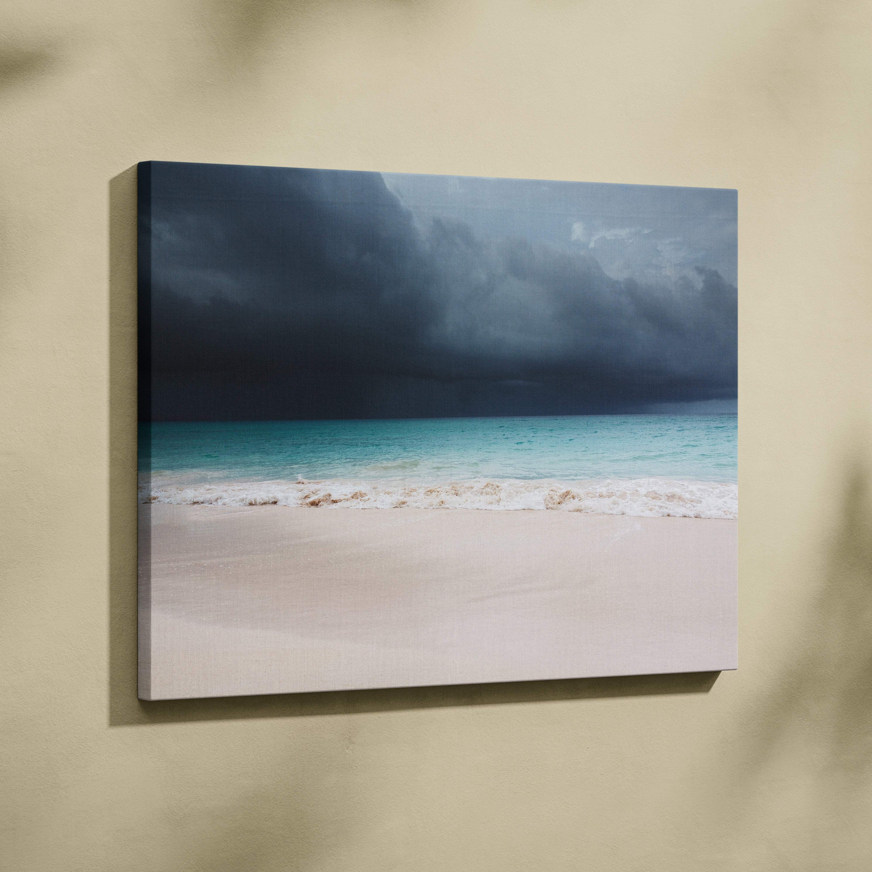A framed canvas print of a stormy beach scene with turquoise waves white sand and dark thunderclouds wall decor