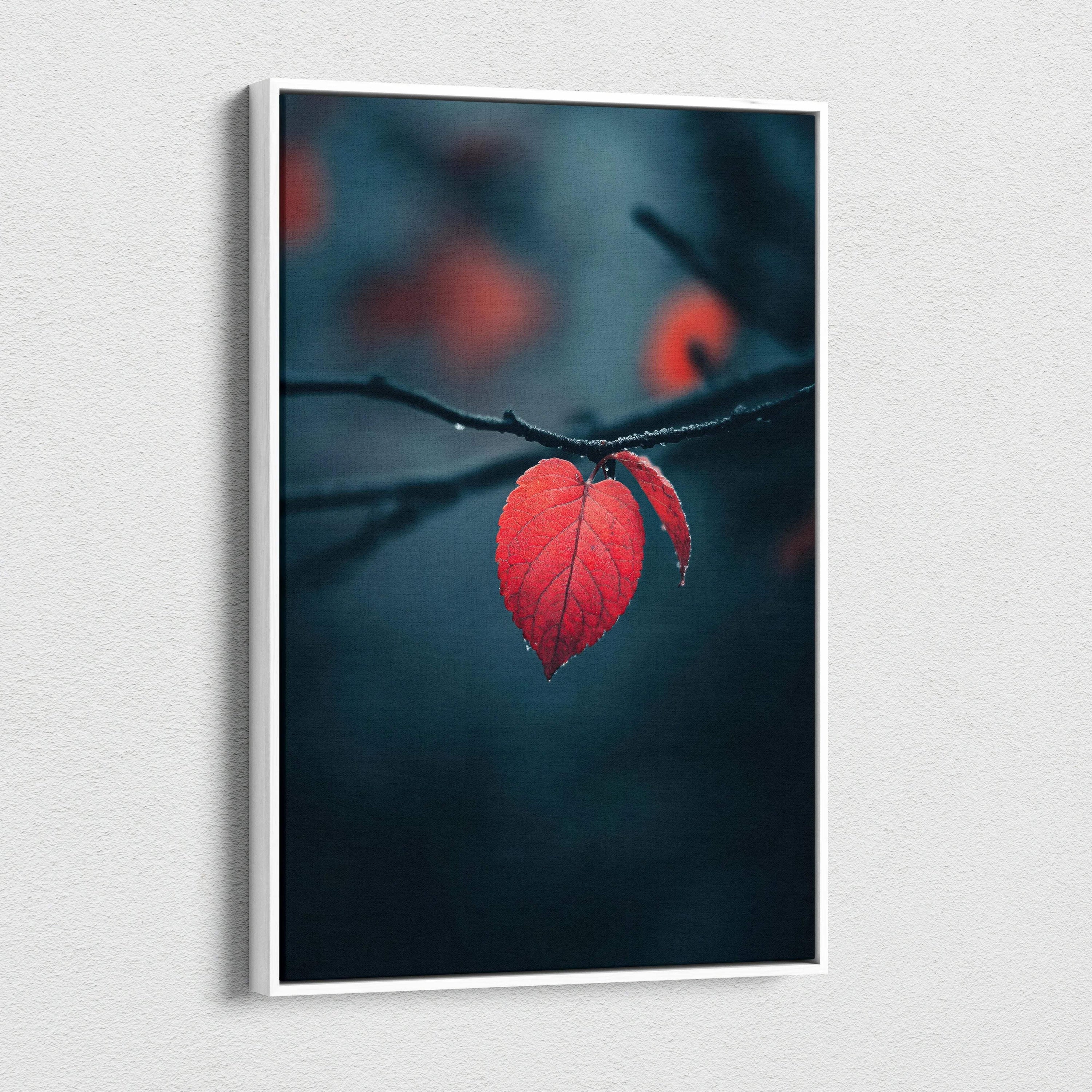 Canvas wall art featuring a close-up of a vibrant red autumn leaf on a dark blurred background.
