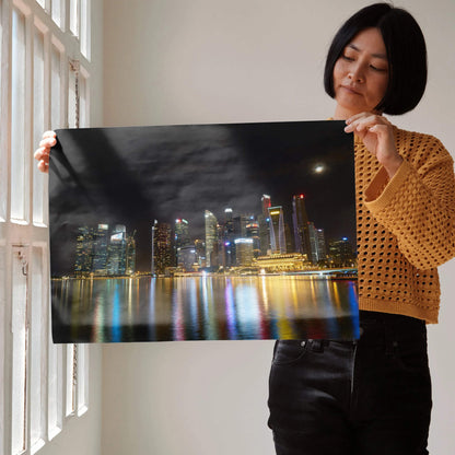 Vibrant city night skyline wall art poster with illuminated skyscrapers and colorful water reflections.