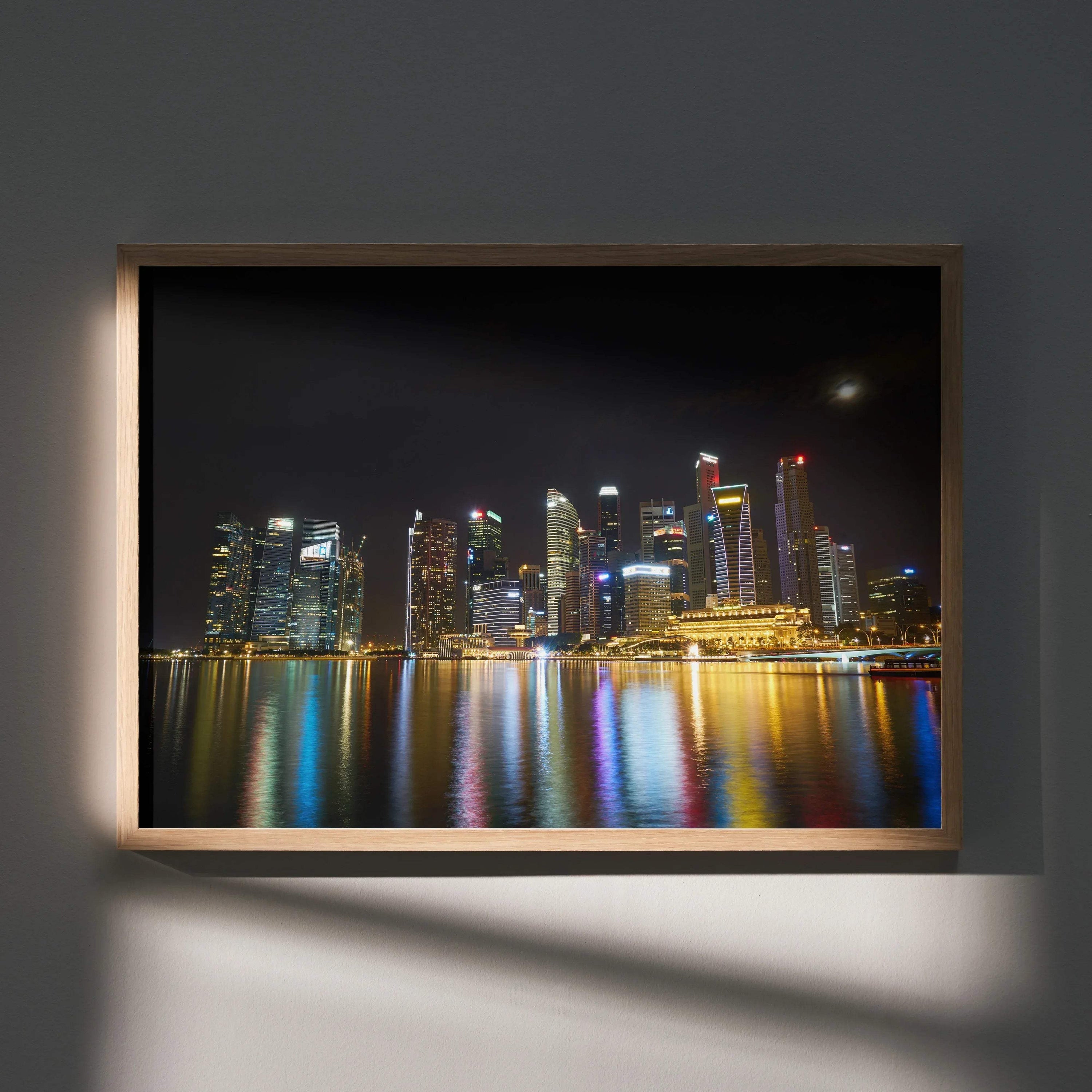 Vibrant city night skyline with colorful reflections on water framed as wall art poster.