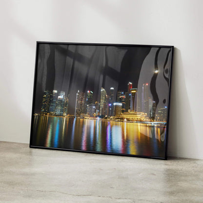 Vibrant city night skyline posters with colorful reflections in water, modern wall art in black frame.