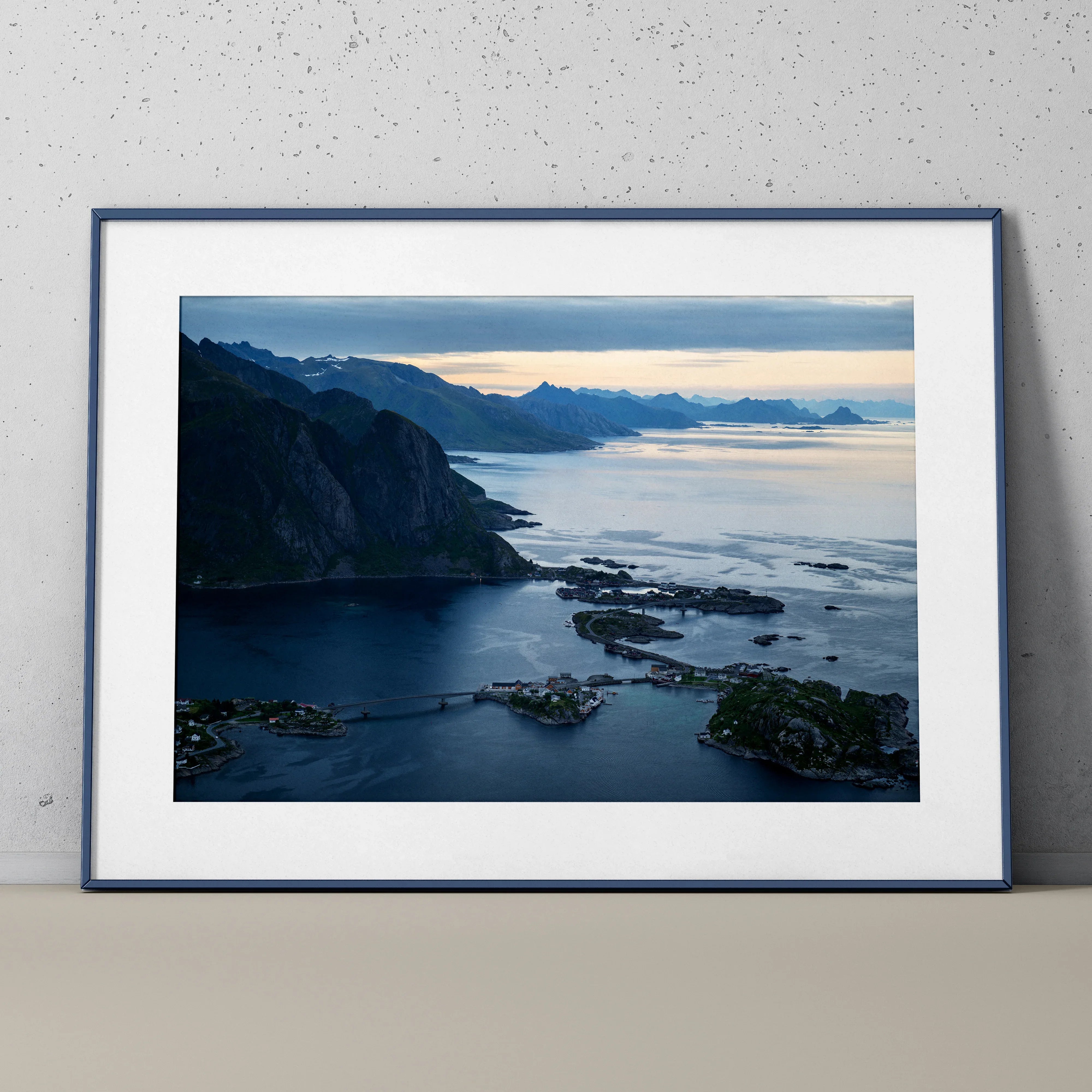 Mountain sunset landscape poster with blue and orange sky, coastal cliffs, and calm water wall art.