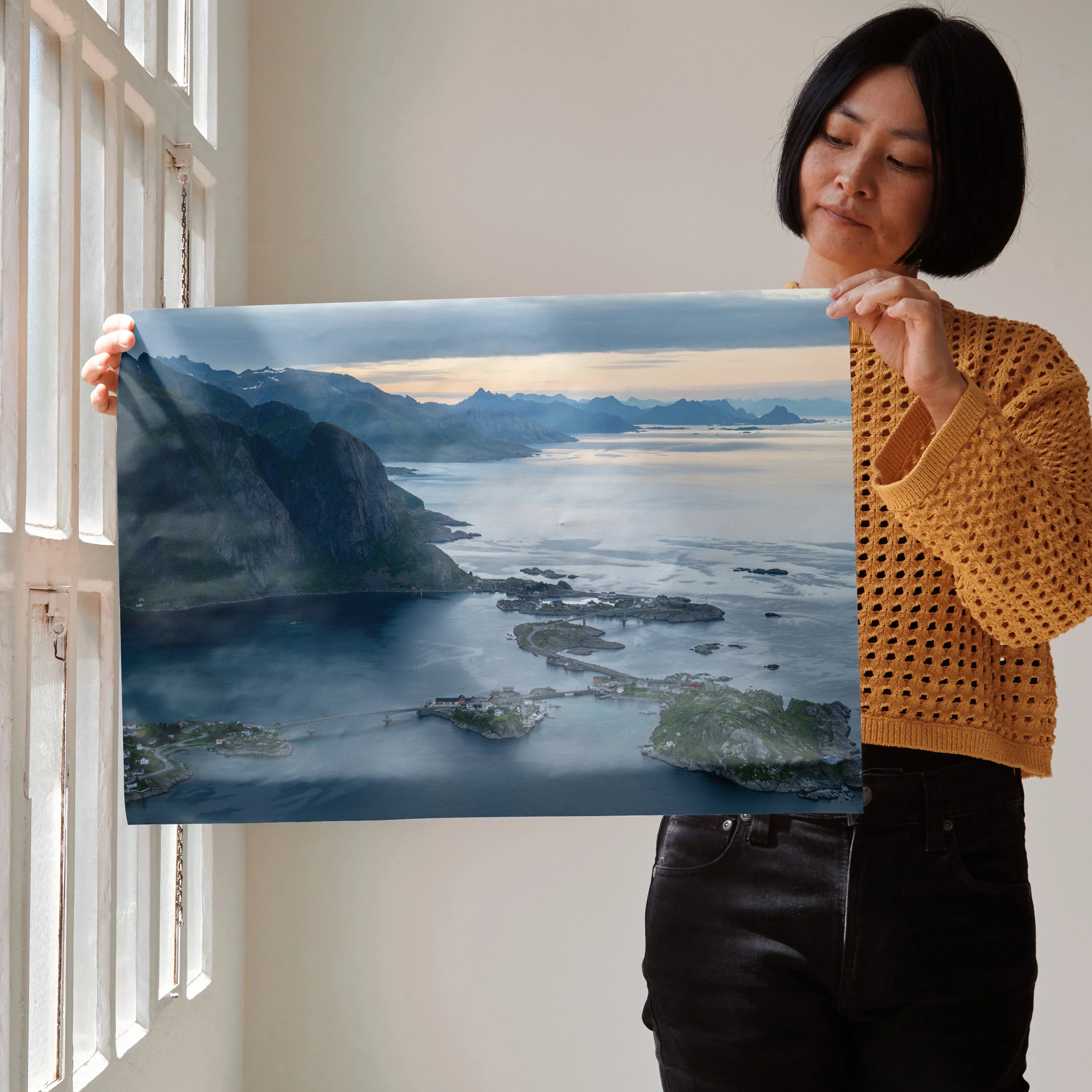 Mountain sunset poster with soft blue and orange hues, serene water and rugged peaks wall art.