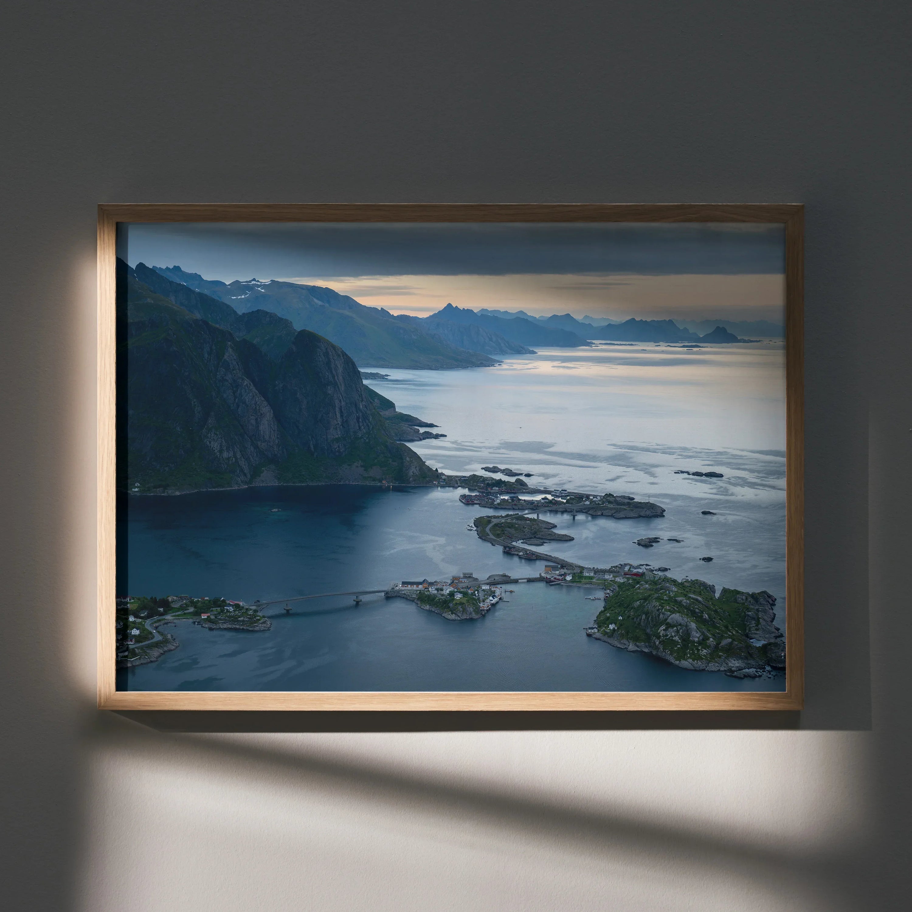 Mountain landscape poster featuring calm water and a soft sunset sky, framed wall art.