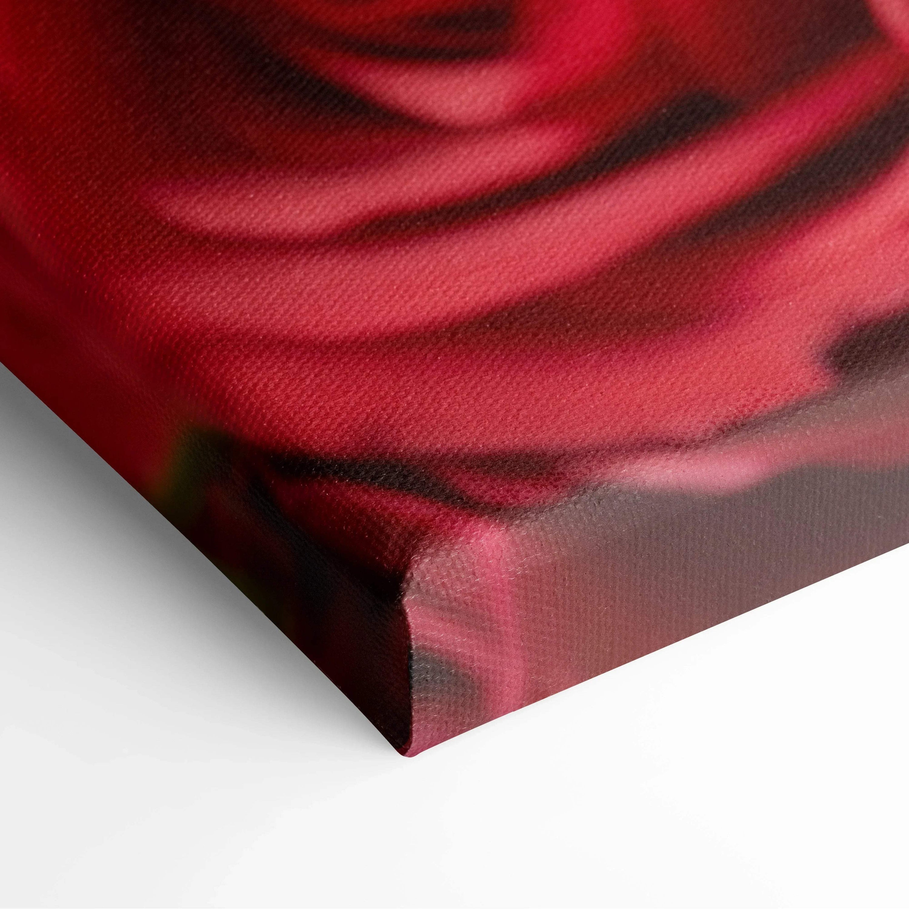 Close-up of vibrant red rose petals printed on textured canvas wall art with wrapped edges for home decor.