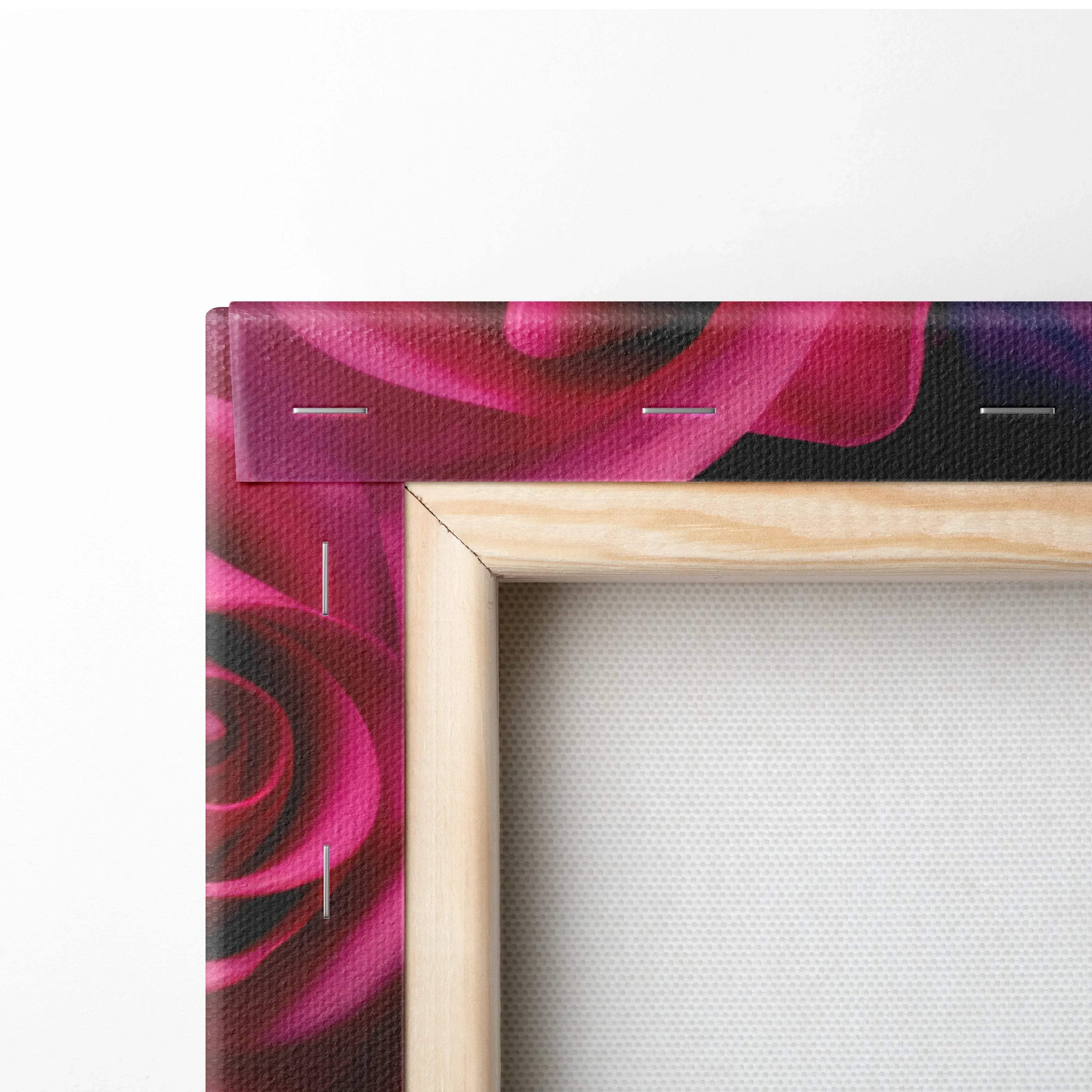 Close-up of wooden frame corner with vibrant pink and purple rose canvas print stretched over it.