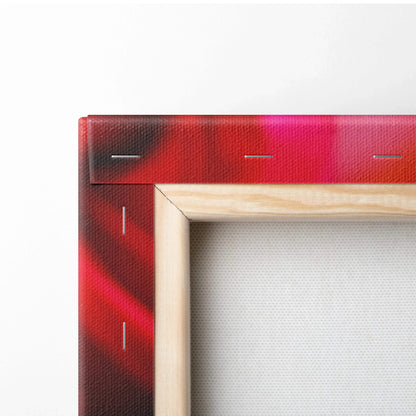 Close-up of wooden frame corner with vibrant red floral canvas wall art decor showing canvas texture and staples.