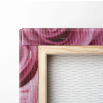 Close-up of canvas wall art corner showing vibrant pink rose petals printed on stretched fabric with wooden frame and.