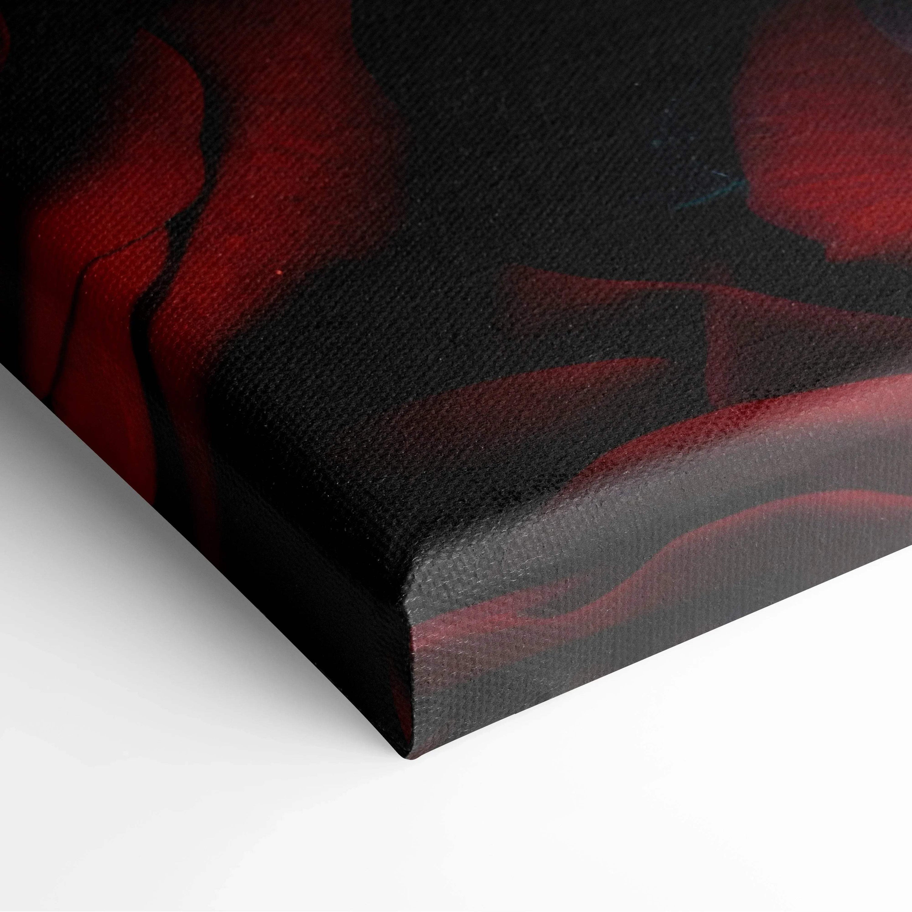 Close-up of vibrant red roses printed on textured black canvas wall art with wrapped edges.