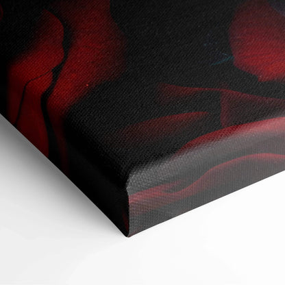 Close-up of vibrant red roses printed on textured black canvas wall art with wrapped edges.