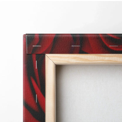 Natural wood frame with canvas stretched over staples on the back featuring vibrant red rose floral wall art.
