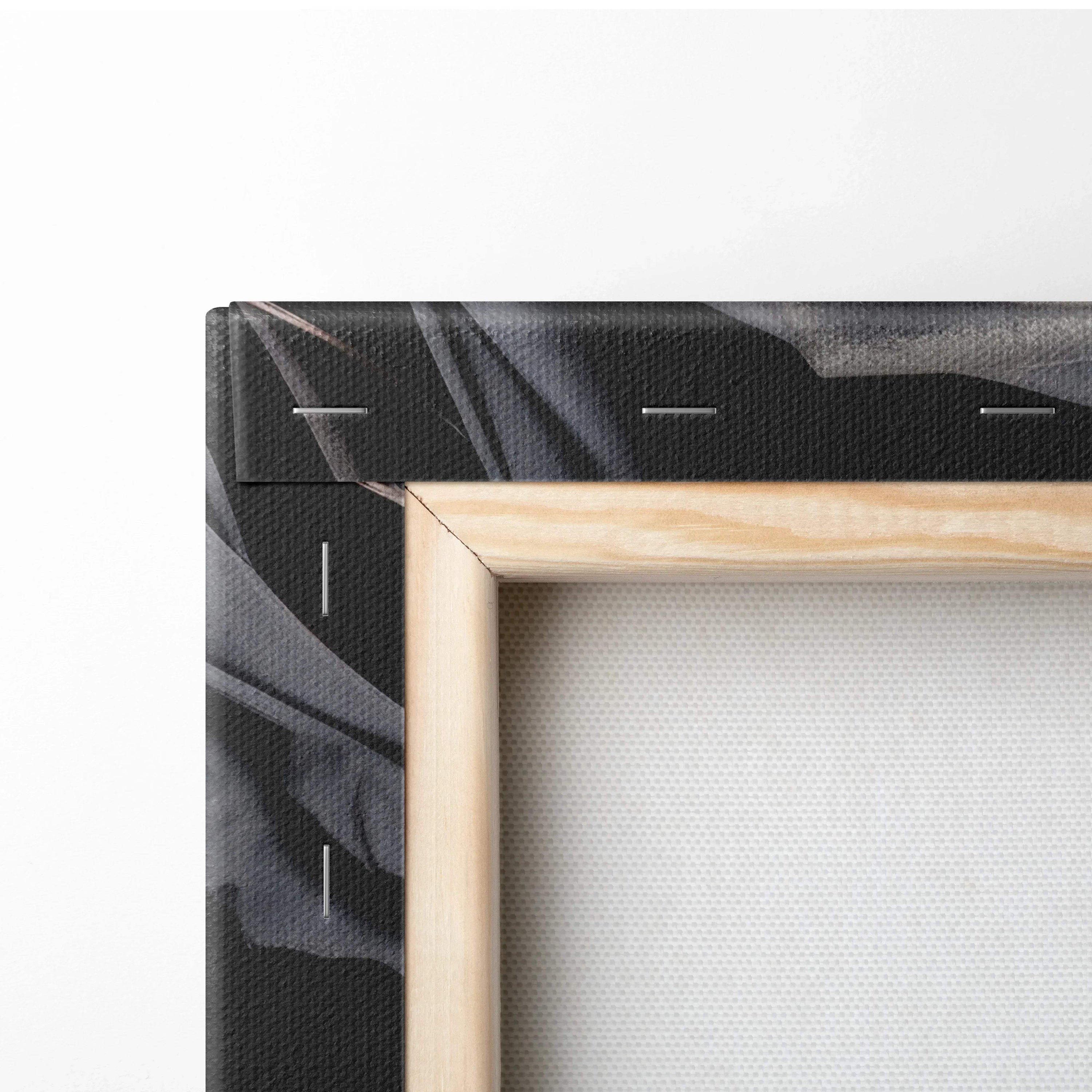 Close-up of wooden-framed canvas with black and dark gray floral wall art print.