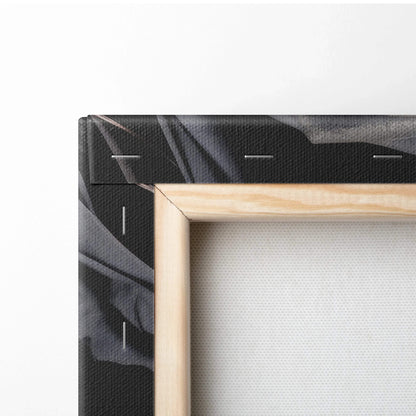 Close-up of wooden-framed canvas with black and dark gray floral wall art print.