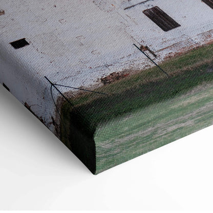 Close-up of canvas wall art corner showing textured city skyline print with sunset hues.