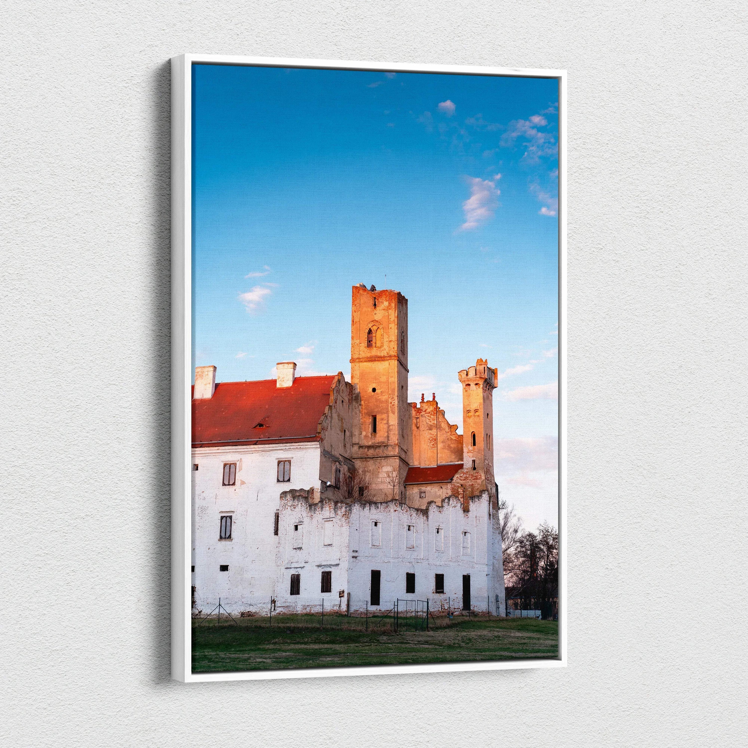 Vertical canvas wall art featuring a historic castle with warm sunset lighting against a clear blue sky.