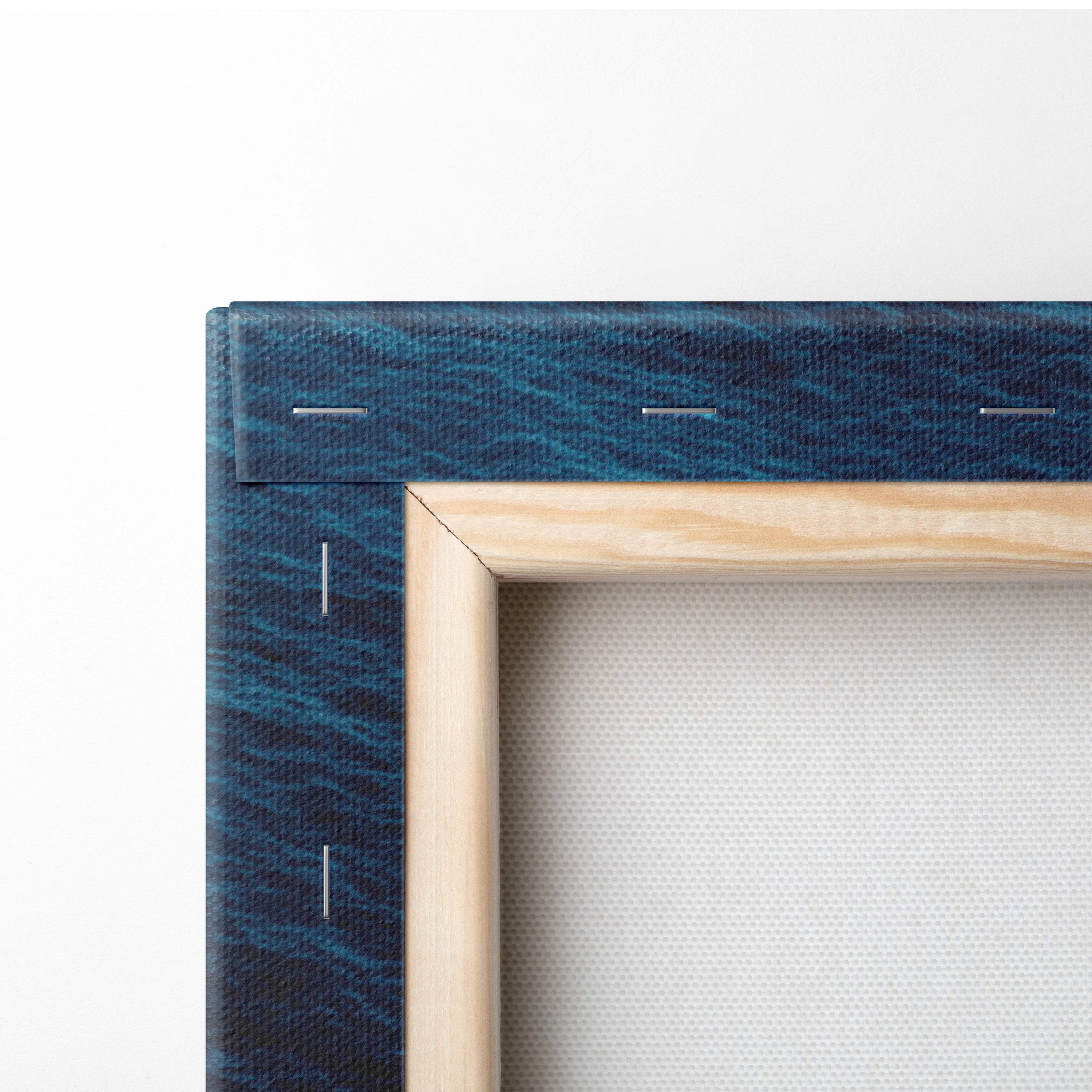 A wooden frame with dark teal textured canvas backing for aerial turquoise ocean coastal wave wall art decor