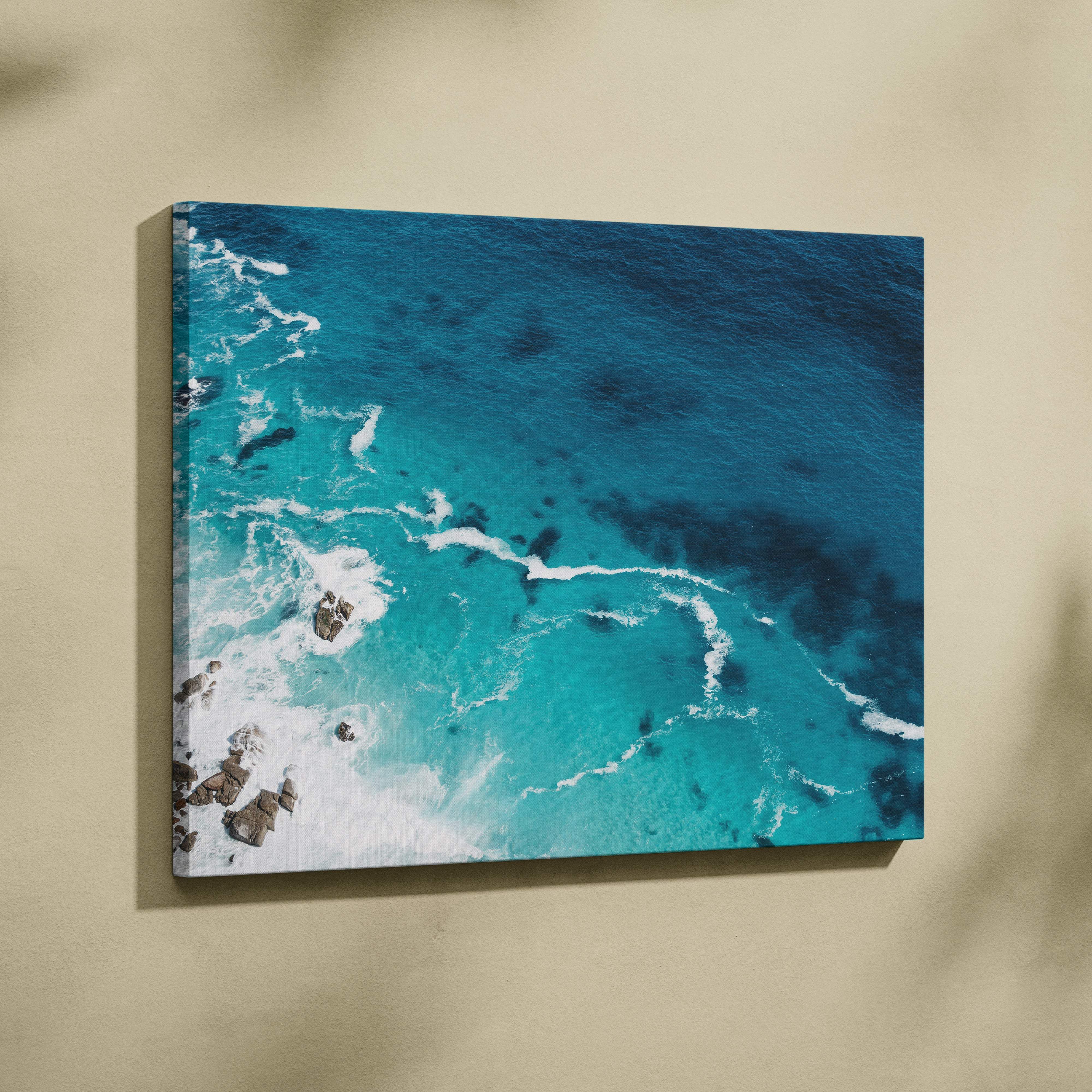 Aerial turquoise ocean canvas wall art print with vibrant crashing waves and rocky outcrops for coastal decor