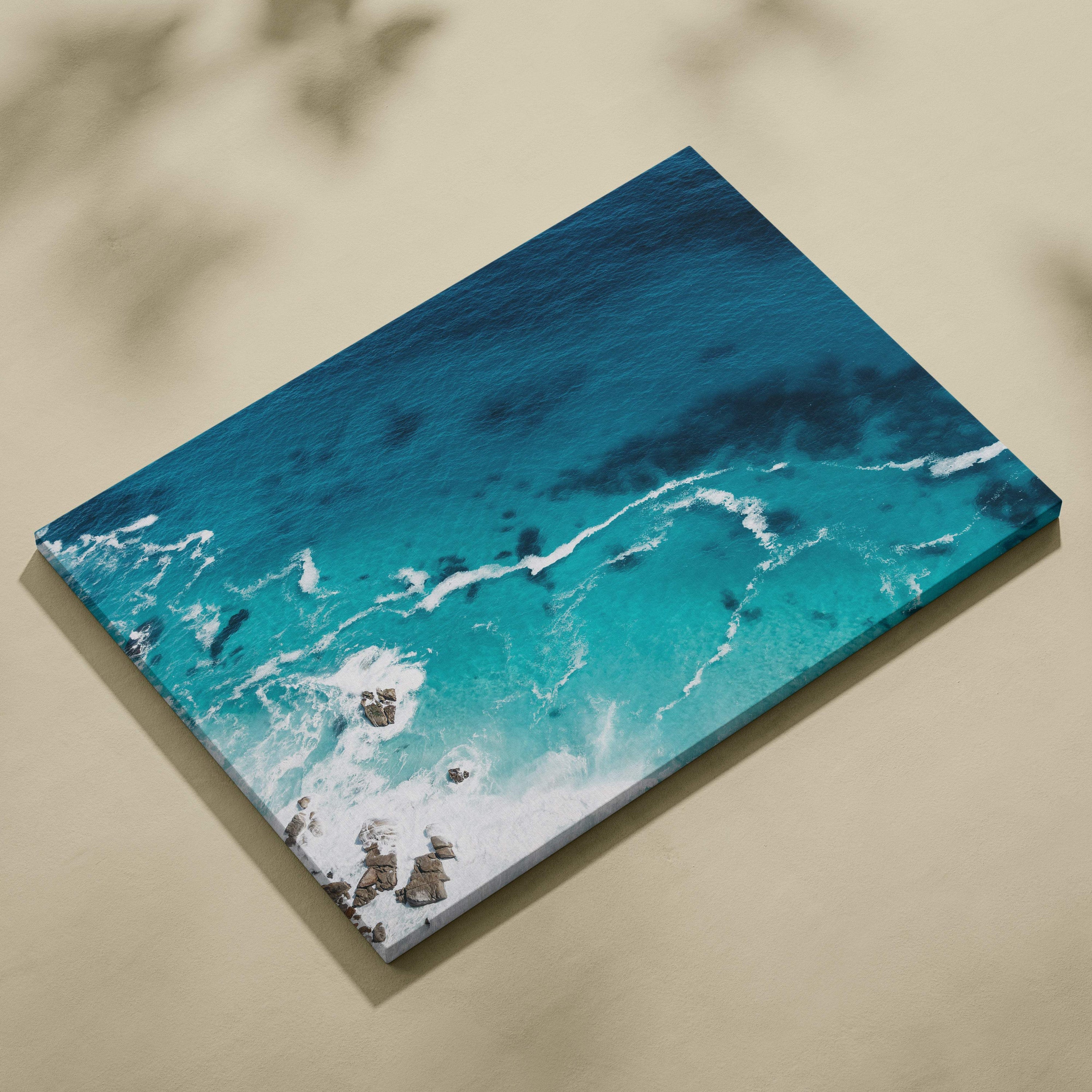 Rectangular canvas wall art print featuring vibrant turquoise ocean waves crashing on rocky shores for coastal decor