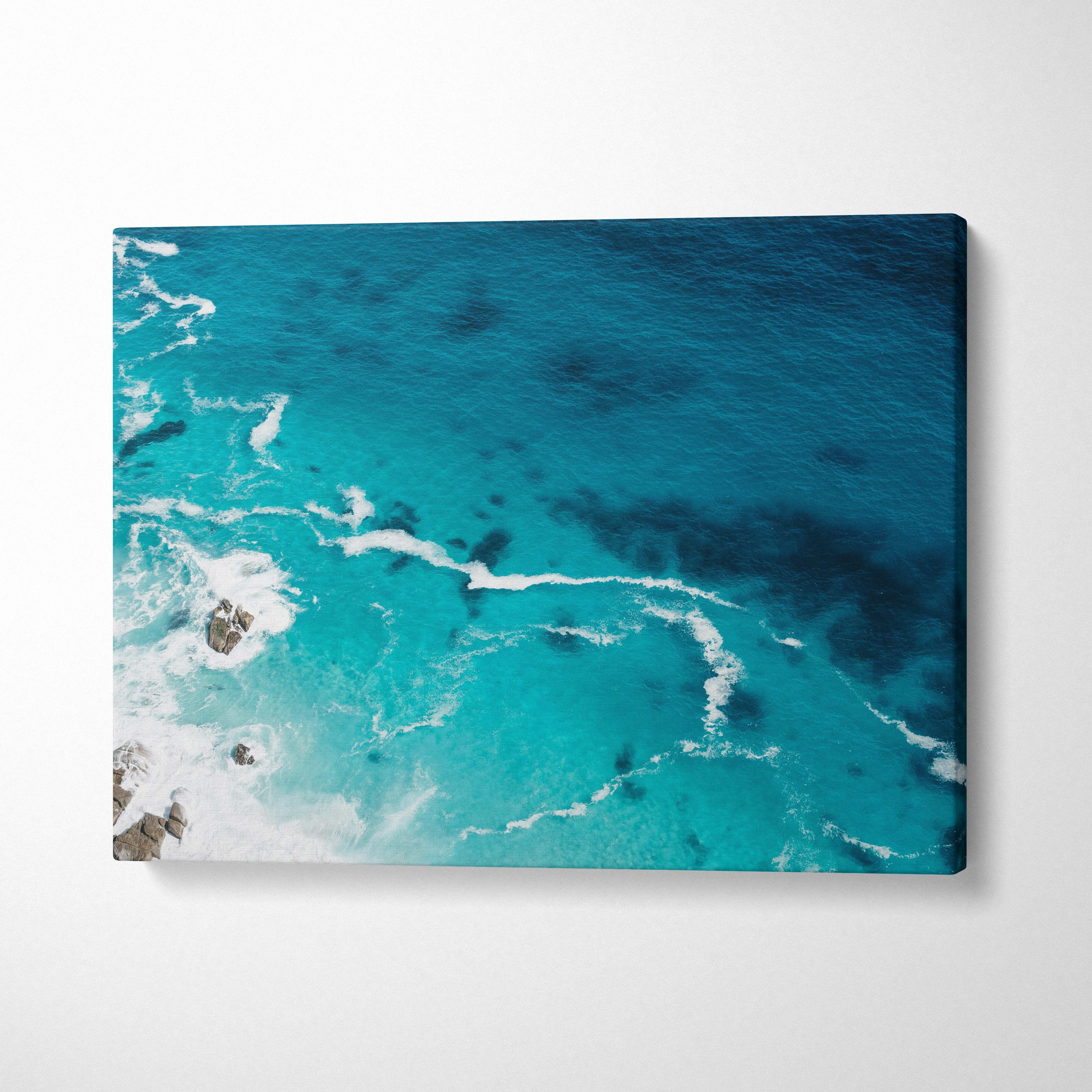 Aerial turquoise ocean canvas wall art print with vibrant crashing waves and rocky outcrops for coastal decor