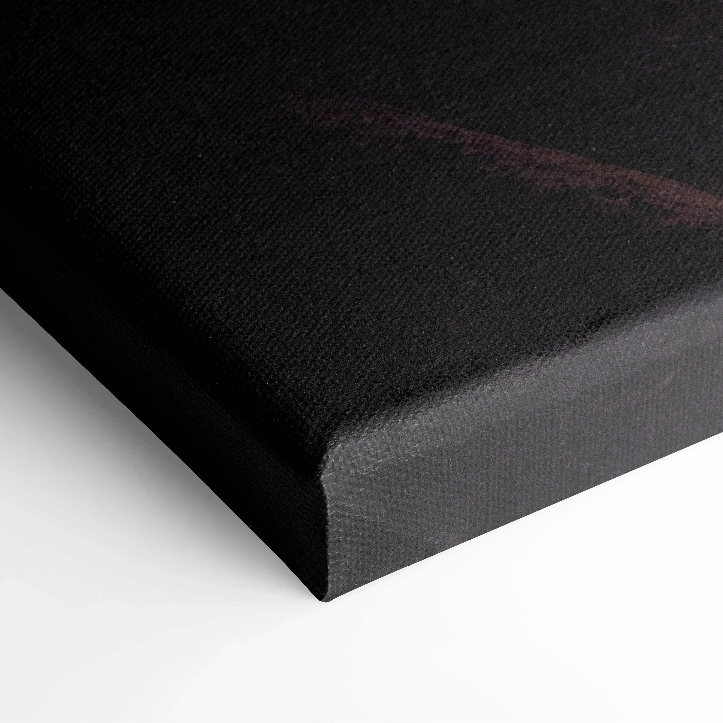 Black canvas wall art corner with subtle dark red tones and textured fabric surface.