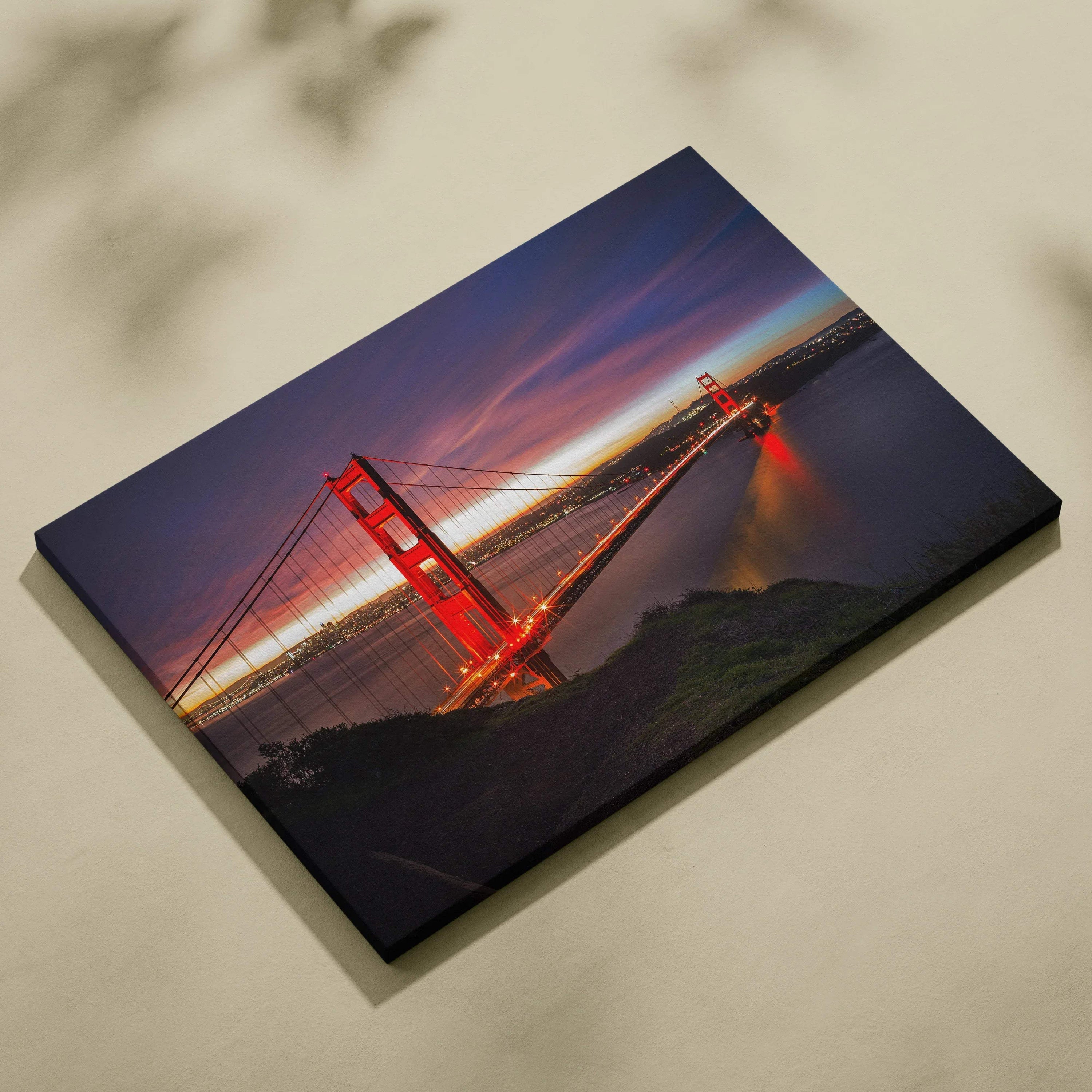 Golden Gate Bridge illuminated at night canvas wall art with deep blue sky and reflections.