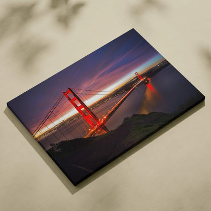 Golden Gate Bridge illuminated at night canvas wall art with deep blue sky and reflections.