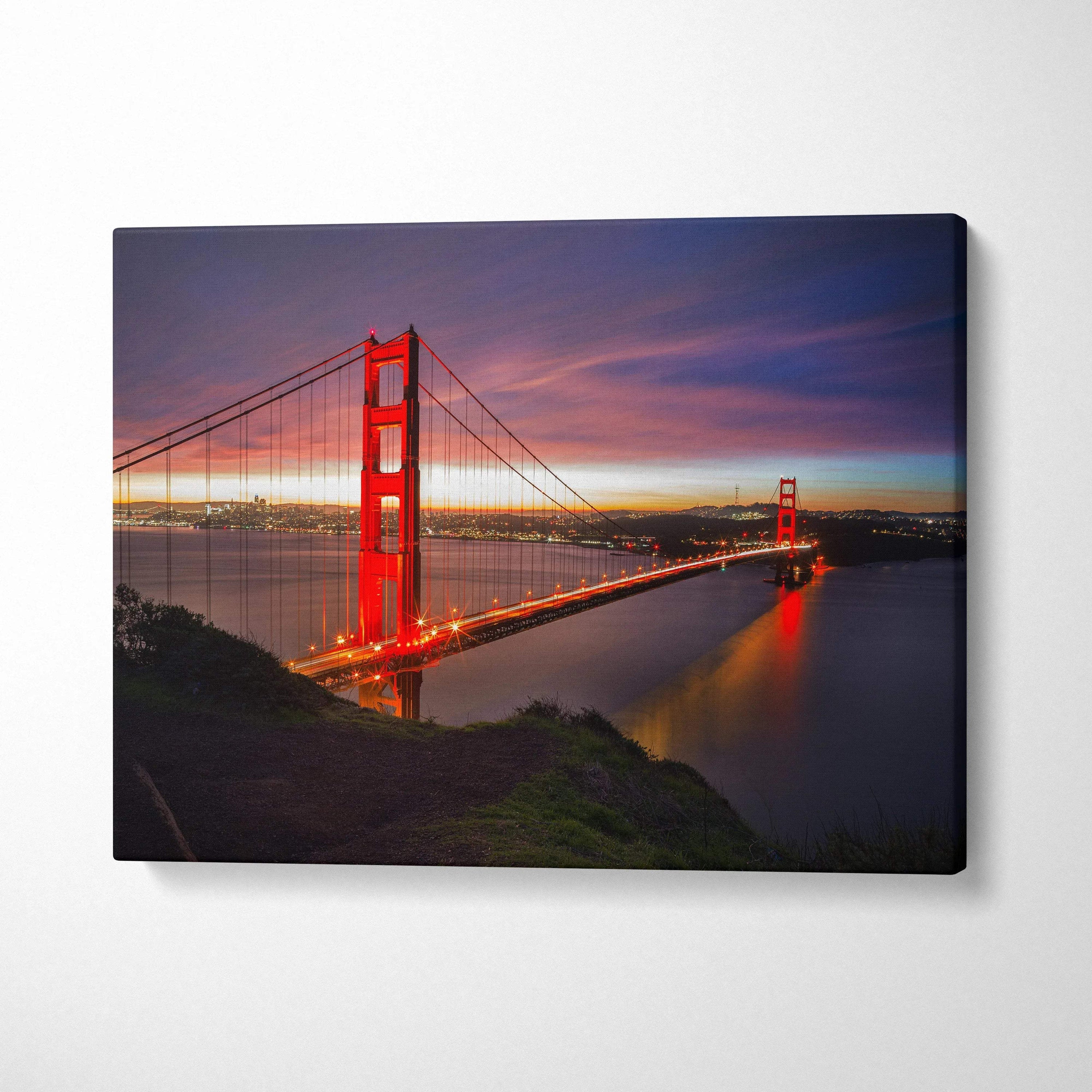 Golden Gate Bridge lit at dusk on canvas wall art with vibrant sky and water reflections.