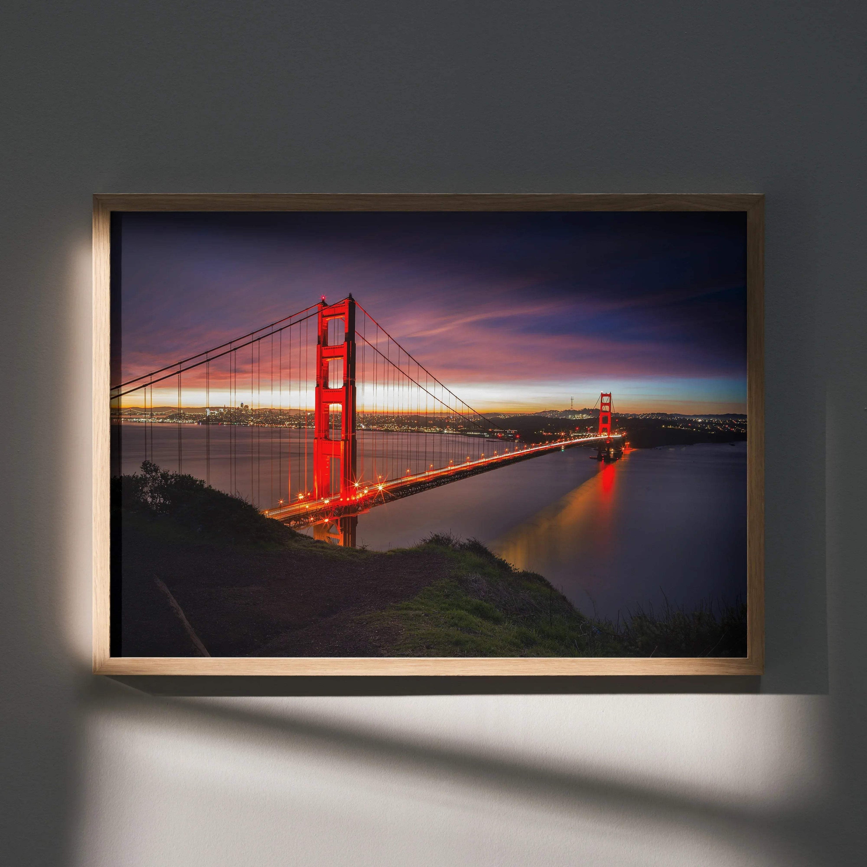 Vibrant city night poster featuring illuminated suspension bridge over calm water, framed wall art.