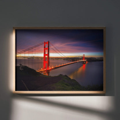 Vibrant city night poster featuring illuminated suspension bridge over calm water, framed wall art.