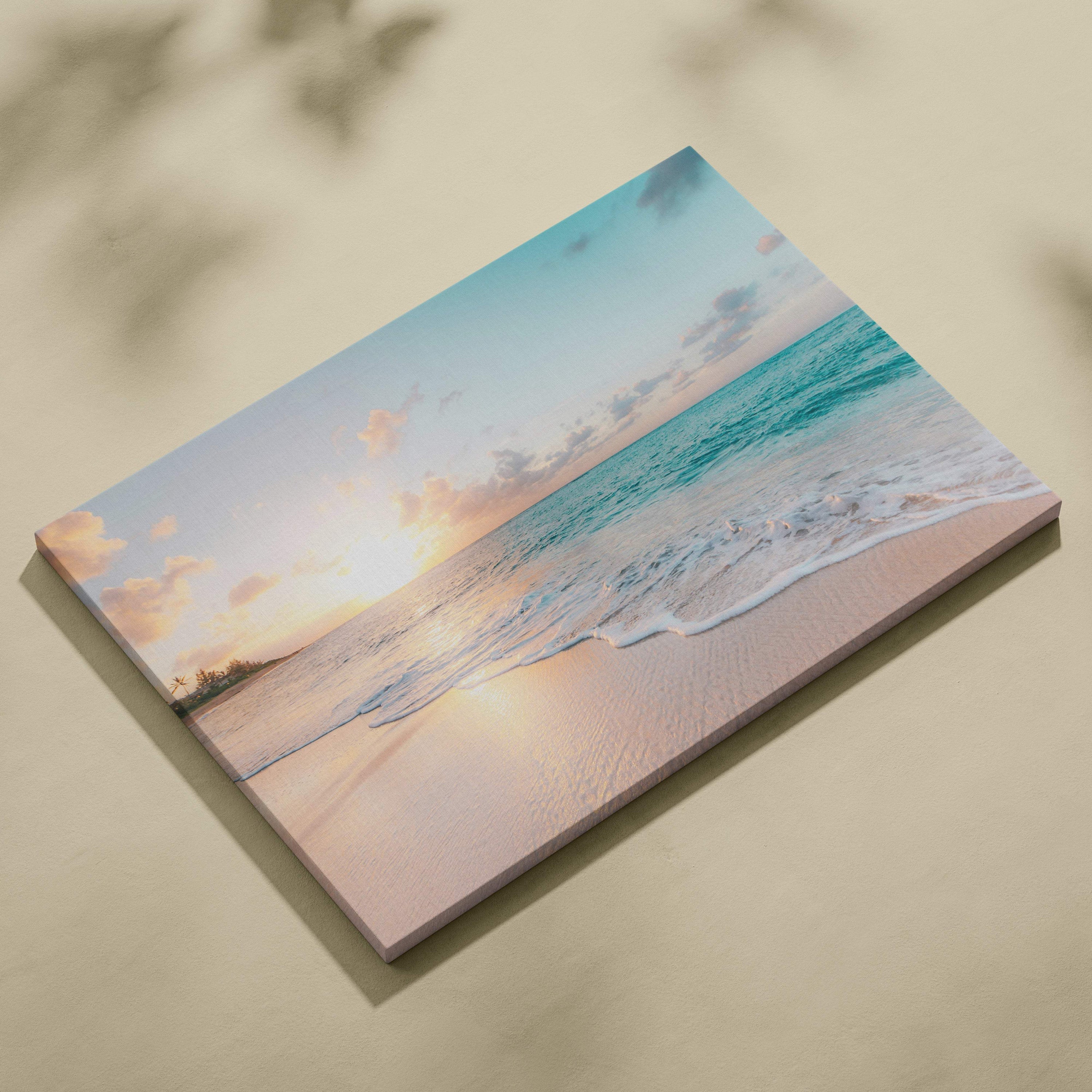 Beige canvas print of a tropical beach sunset with turquoise waves and soft pink clouds for coastal decor