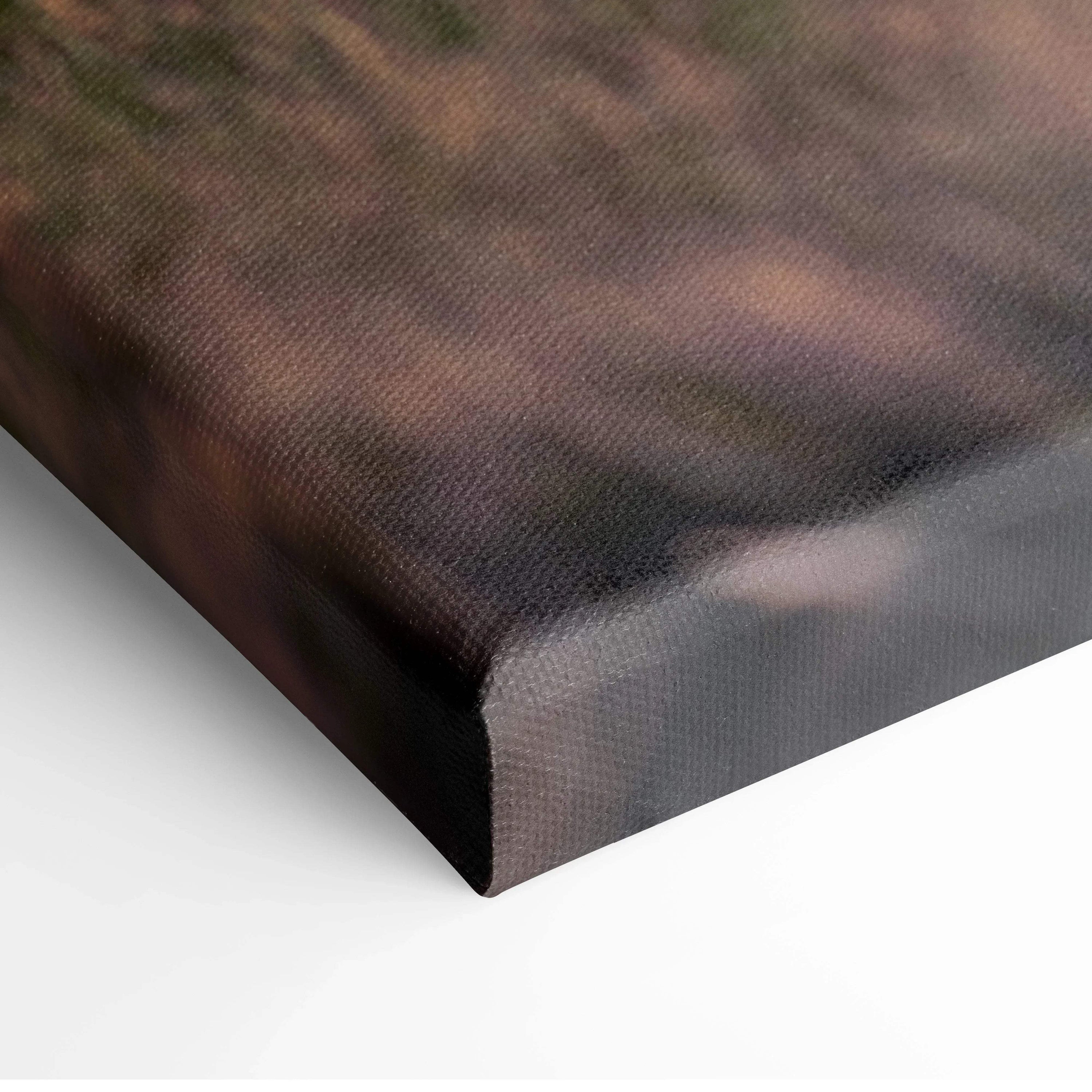 Canvas wall art featuring a sunset over mountains and buildings with warm golden tones.