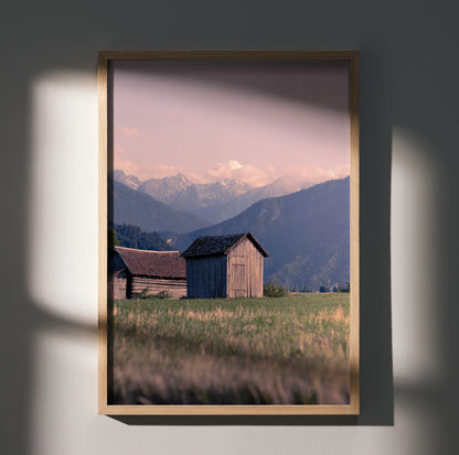 Majestic mountain landscape poster with wooden barns and soft sunset sky wall art.