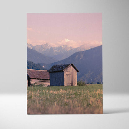 Canvas wall art featuring golden sunset over mountains with rustic wooden buildings.