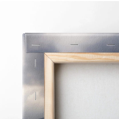 Back of light wood frame with gray canvas, sunlit valleys under stormy mountains