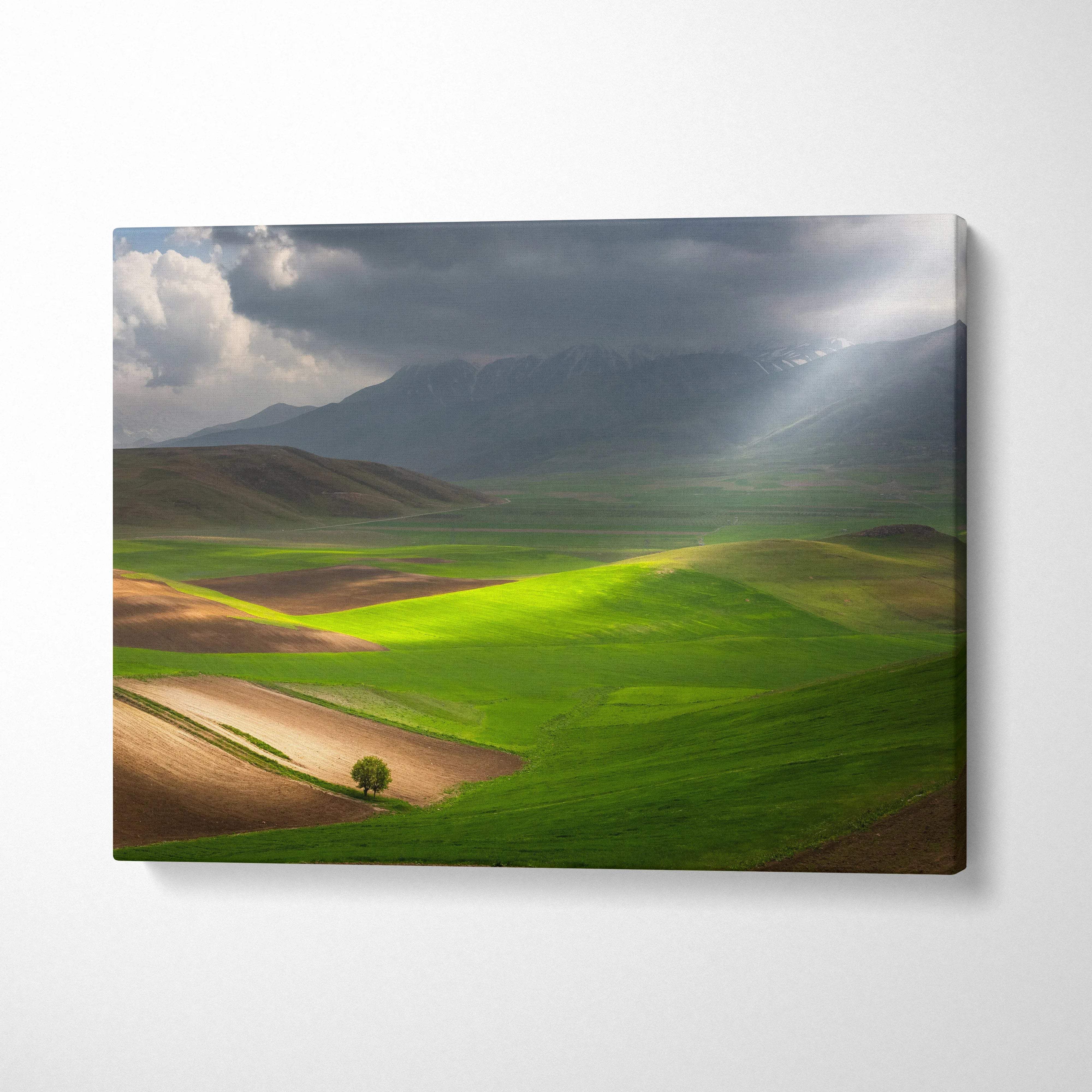 Cinematic canvas print of sunlit valleys, rolling green fields, stormy mountains