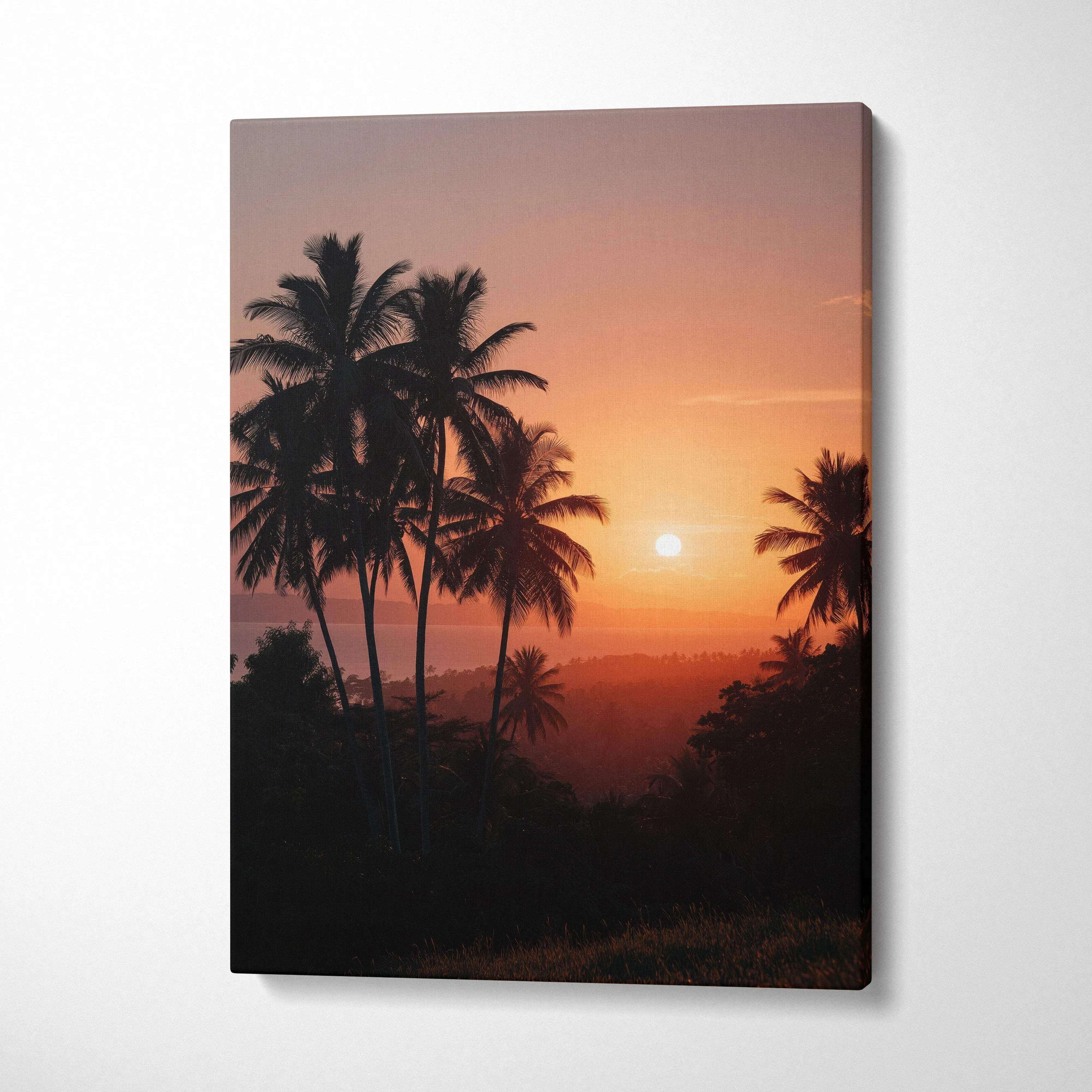 Canvas wall art featuring a vibrant beach sunset with silhouetted palm trees against an orange sky.