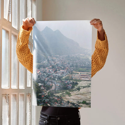 Urban cityscape art poster with colorful buildings and misty mountains, vibrant wall art.