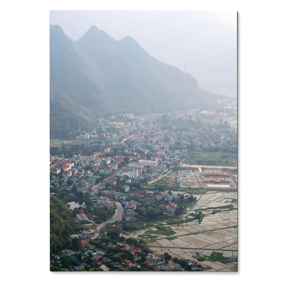 Vertical art poster of a misty urban cityscape with mountains and sprawling buildings wall art.