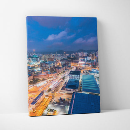 Vibrant modern cityscape canvas wall art featuring illuminated buildings and streets at dusk.