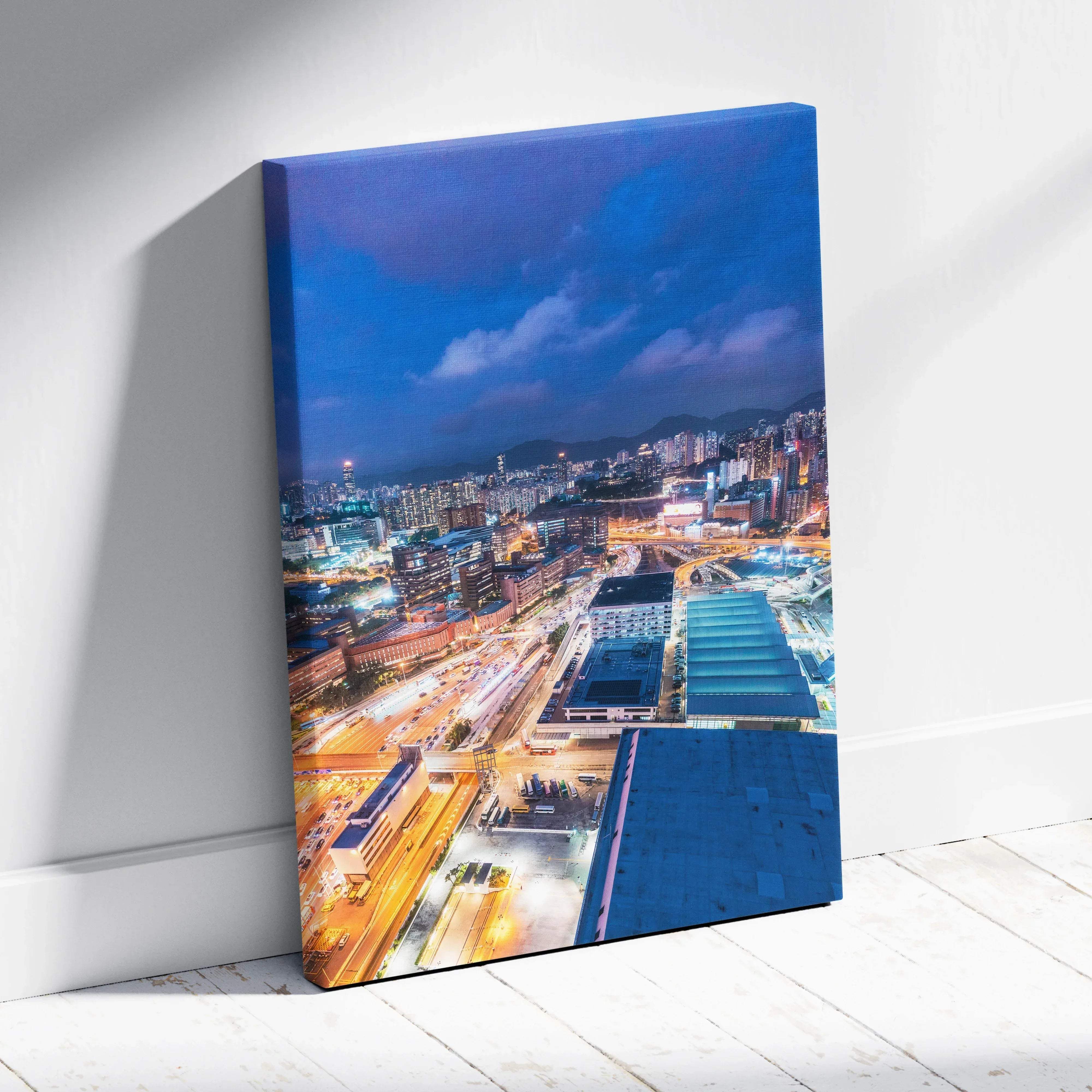 Modern cityscape night neon lights skyline blue and warm orange canvas wall art print leaning against white wall