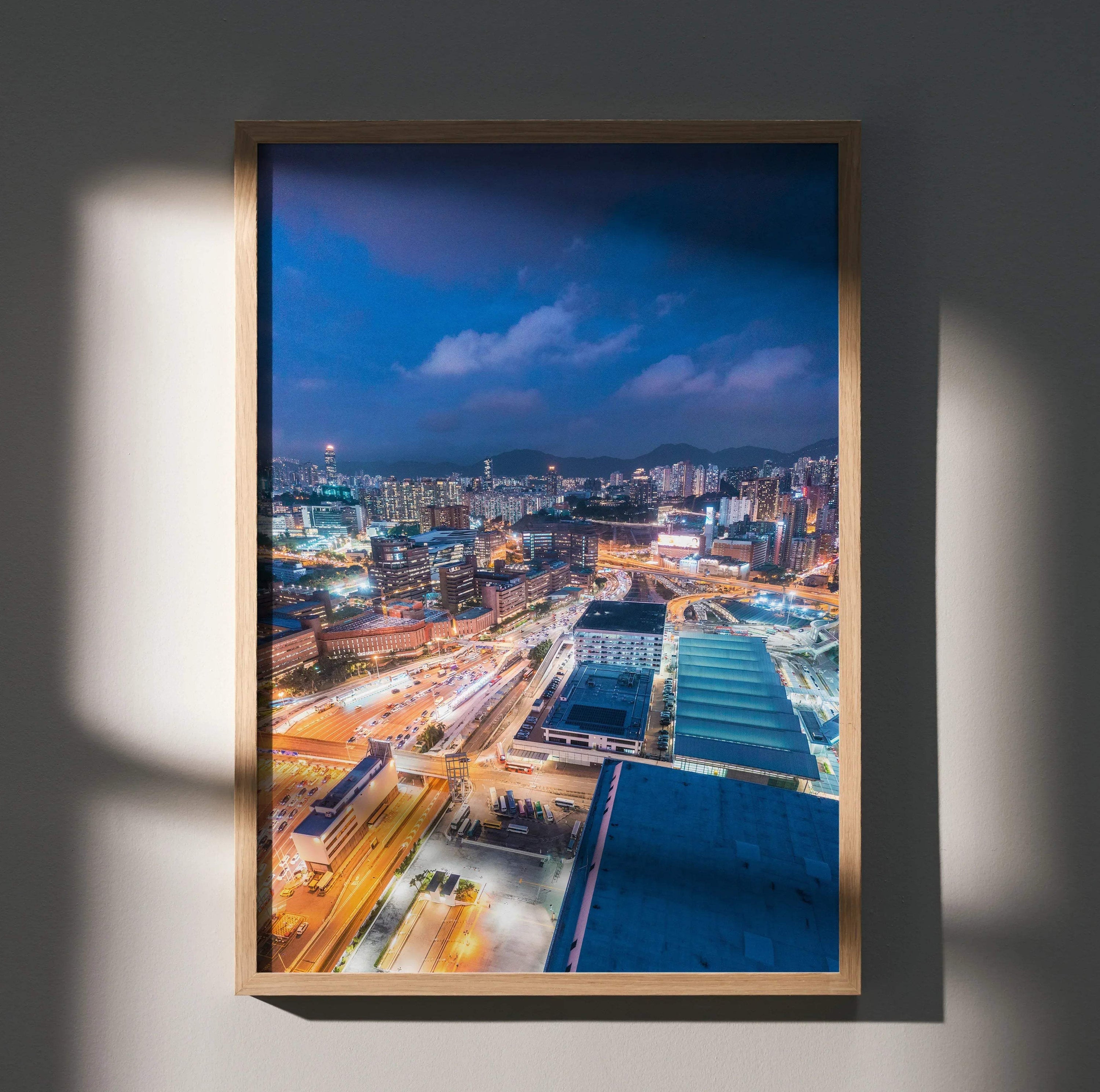Urban night skyline wall art poster with illuminated city lights in a wooden frame.