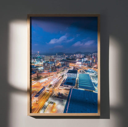 Urban night skyline wall art poster with illuminated city lights in a wooden frame.